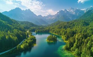 Mountain lake surrounded by lush forests and towering peaks in a clear blue sky photo