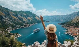 Woman waves at cruise ship while overlooking scenic fjord in Kotor Montenegro photo