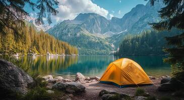 Beautiful yellow tent beside serene lake with mountains and trees in bright daylight photo