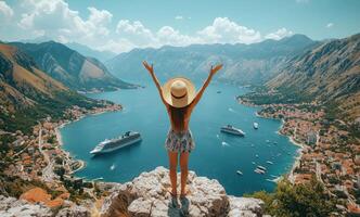 Scenic view of woman celebrating on a cliff above Kotor Bay in Montenegro on a sunny day photo