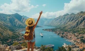 Breathtaking view of a woman waving from a mountain overlooking Kotor Bay in Montenegro on a sunny day photo