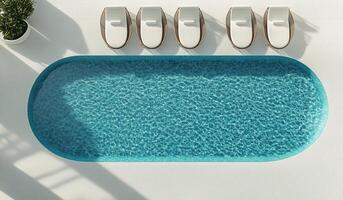 Relaxing atmosphere at a modern swimming pool with lounge chairs under clear skies photo