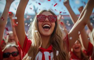 A woman in red and white sunglasses is celebrating photo