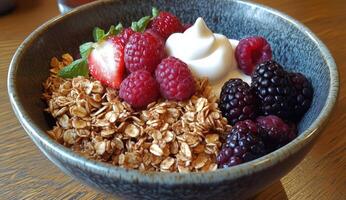 A bowl of granola with berries and yogurt photo