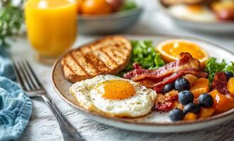 Breakfast with eggs, bacon, and fruit photo