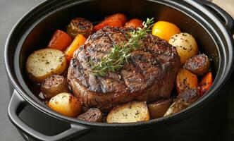 Delicious beef roast with vegetables and herbs cooked to perfection in a black pot photo