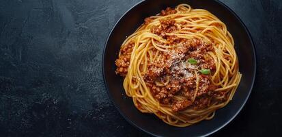 Spaghetti with meat and sauce on black background photo