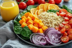 A plate of vegetables and a glass of orange juice photo