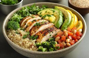 A bowl of food with chicken, vegetables and rice photo