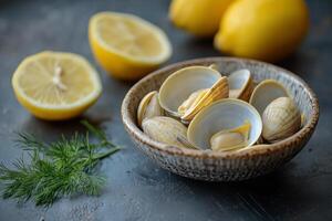 Clams in a bowl with lemon slices and dill photo