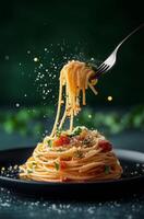 Spaghetti with tomato sauce and parmesan cheese on a black plate photo