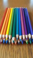 A group of colored pencils on a wooden table photo