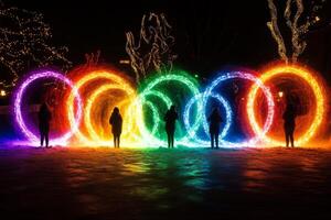 A group of people standing in front of a group of colorful rings photo