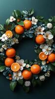 A wreath of oranges and flowers on a green background photo