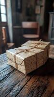 Three wrapped gift boxes sitting on a wooden table photo