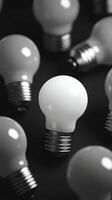 Many light bulbs are grouped together in a black and white photo