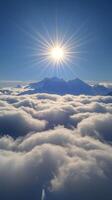 The sun shines over the clouds and mountains photo