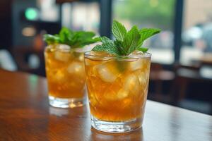 Two glasses of iced tea with mint leaves on top photo