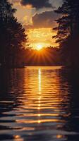 Sunset over a tranquil lake in a forested area reflecting vibrant colors and silhouettes photo