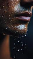 A close up of a man's face with water droplets on it photo
