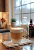 Warm coffee drink with milk froth on a cozy kitchen counter in winter time photo