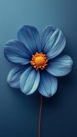 Beautiful blue flower with vibrant orange center on a dark blue background photo