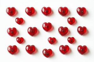 Bright red heart-shaped jelly candies displayed on a white background for decoration or celebration photo