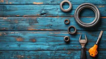 Various metal gears and tools arranged on a rustic blue wooden surface during afternoon light photo