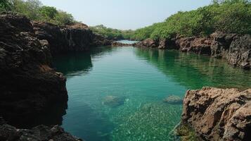 Tranquil turquoise waters surrounded by rocky cliffs and lush greenery photo