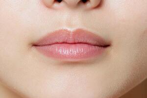 Close up of a womans lips with glossy lip balm photo