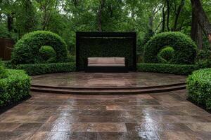 A tranquil outdoor seating area with manicured hedges and a comfortable couch photo