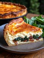 A slice of delicious quiche with spinach and caramelized onions photo