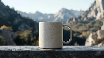 A speckled mug sits on a stone surface with a mountain backdrop photo