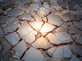 Abstract shattered mirror background with light shining through the cracks photo
