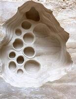 Abstract wall art with circular openings in a layered design photo