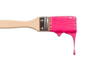 Paintbrush with fresh pink paint splatter on white background Clean image of a paintbrush with pink paint splatters on a white background great for art projects or creative content photo