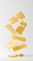 Soft and hard cheese pieces dropping on white background. Tasty cheese falling from the top for dairy and food visuals photo