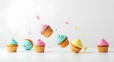 Assorted cupcakes falling down on white background Detailed image of different colored cupcakes falling mid-air on a white background perfect for baking tutorials dessert ads or playful food visuals photo