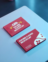 Two red name card mockups rest on a light blue surface psd