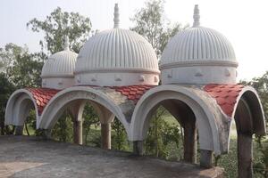 A large white building with red and white domes photo