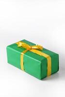 Portrait-Style Image of a Green Present with a Golden Ribbon photo