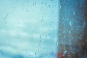 Rainy window view, Drops on glass on rainy cloudy day evoke melancholy and sadness. View of city from the window. Selective focus. High quality photo