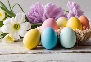 brightly colored eggs in basket surrounded by green grass and flowers. Perfect for Easter celebrations and creating a spring mood. photo