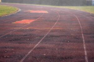 View of an old running track at a street stadium in the early morning photo