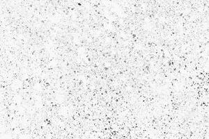 Abstract grunge texture with black speckles and scattered dots on a white background, great for artistic designs. photo