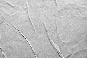 Gray wrinkled paper texture with subtle folds and creases, ideal for design projects or artistic overlays. photo