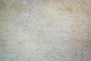 Neutral textured wall surface with soft beige and pastel tones, ideal for backgrounds and design templates. photo