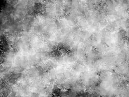 Abstract grunge texture featuring a cloudy marble-like pattern in black and white, with a speckled, starry appearance. Perfect for backgrounds, overlays, and design projects. photo