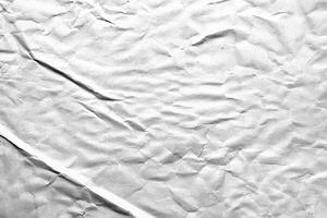 Crumpled white paper texture with detailed folds and wrinkles, ideal for backgrounds or overlay effects. photo
