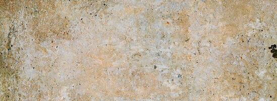 Rustic weathered concrete texture with earthy tones, cracks, and rough details, perfect for vintage design use. photo